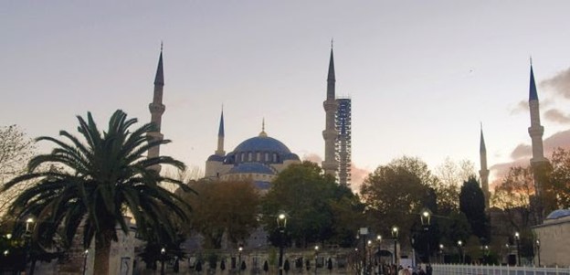 Overcast sunset view of Sultanahmet (Blue Mosque) and its six minarets. One wrapped in scaffolding.