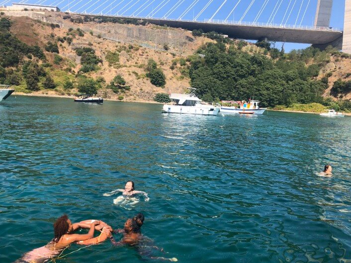 People and boats in the water of the Bosphorus