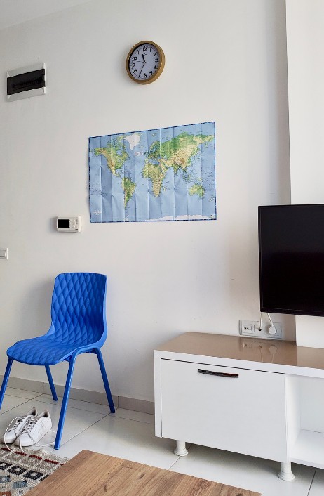 foldable map of the world hanging on a wall