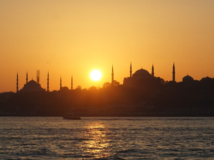 Golden sunset view of Istanbul's Sultanahmet (Blue Mosque) and Hagia Sophia and its minarets.