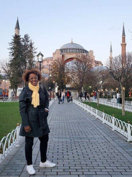 woman standing on walkway with Hagia Sophia mosque in the background